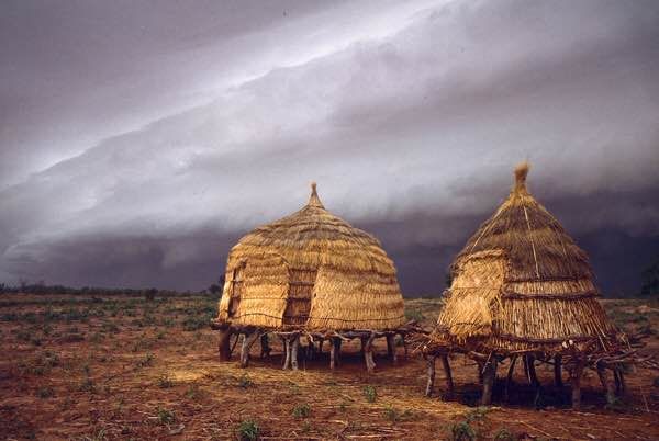 Granaries under a stormy sky